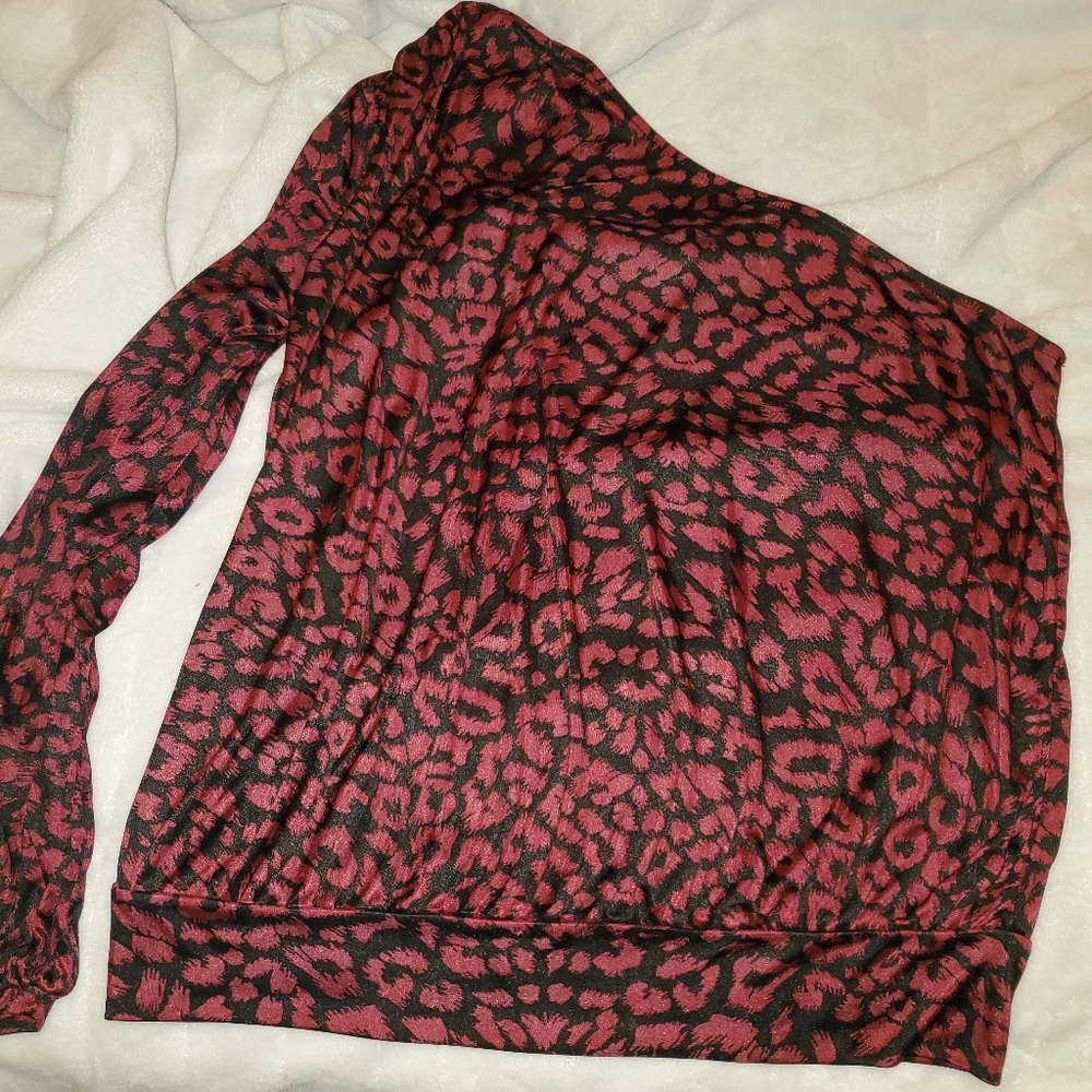 Woman's off shoulder top. Left arm has slit.
